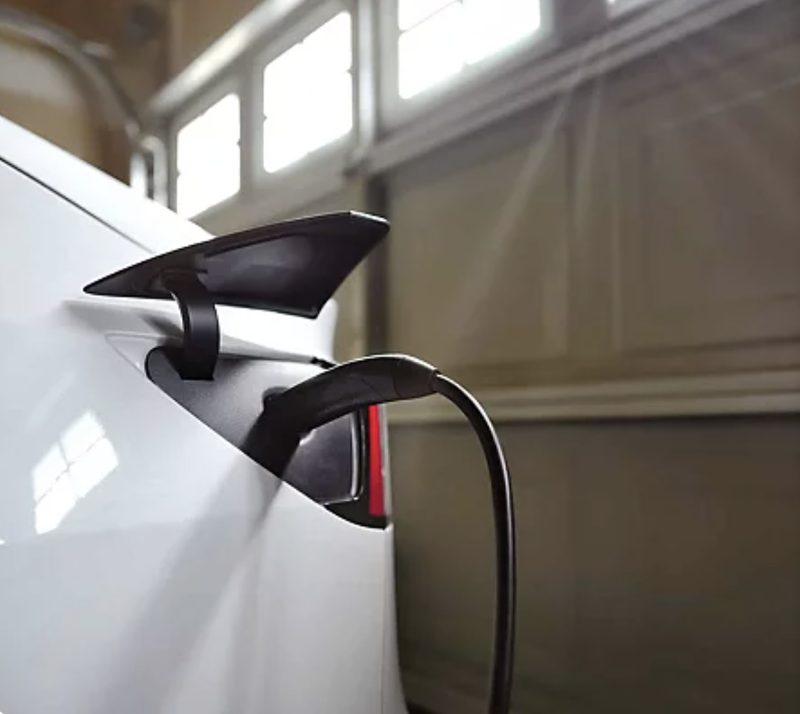 Grizzl-E Level 2 EV charger installed on an exterior garage wall in a residential driveway