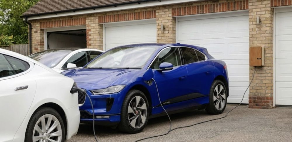Two EVs charging at a home with installed chargers